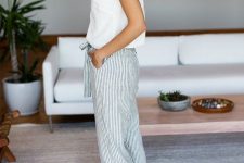 a white top with bows on shoulders, cropped pinstripe pants, white espadrilles and statement earrings