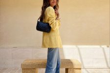 a yellow linen blazer, blue jeans, black dad sandals and a black bag for a bright and cheerful sumemr work look