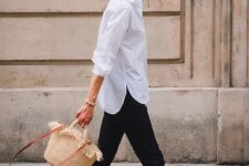 an elegant summer work look with a white shirt, black jeans, printed birkenstocks and a woven bag is easy and chic