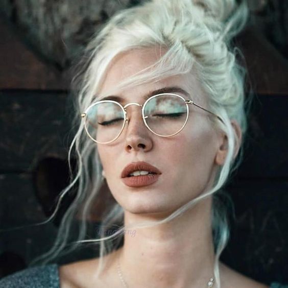 thin framed round glasses in a gold metal frame is a veyr trendy accessory that will give a slight nerdy look