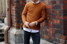 10 a bold fall outfit with a white shirt, a rust-colored jumper over it, black jeans and white sneakers