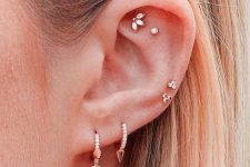 10 gorgeous modern ear styling with a double flat piercing, a double low helix and a double lobe done with studs and with hoops