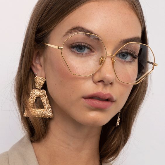 delicate hexagonal eyeglasses in a thin gold frame is a veyr chic and bold idea if you wanna make a statement