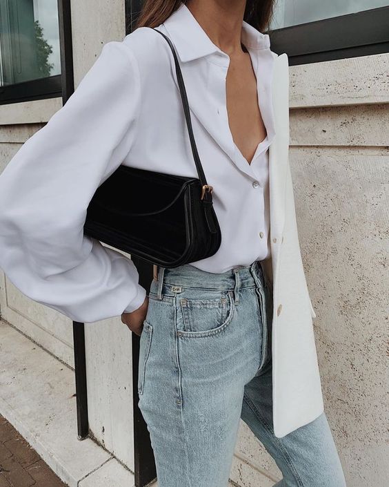a basic fall outfit with a white shirt, light blue jeans, a creamy oversized blazer and a black bag