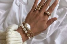 16 fantastic stacked bracelets of chain and usual and baroque pearls and statement gold rings with pearls, too