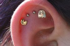 22 funny and cheerful stacked flat piercings done with studs that show off a famous game is are very bold idea
