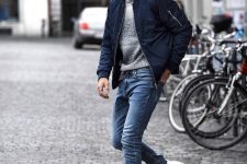 24 agrey jumper, blue jeans, white sneakers, a navy bomber jacket for a stylish and chic look
