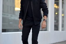 25 a total black look with a t-shirt, sweatpants, a bomber, sneakers and a watch is very chic and bold