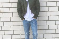 26 an easy look with a white t-shirt, blue jeans, a green bomber jacket and a black baseball cap is simple and cool