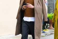 40 a white shirt, a mustard jumper, grey trousers, white sneakers and a plaid coat for a very stylish fall look