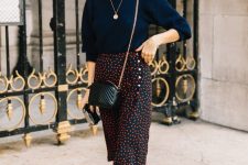 44 a stylish fall outfit with a navy jumper, a polka dot black and red midi, black boots and a black crossbody bag