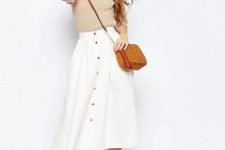 With beige shirt, brown crossbody bag and white platform sandals