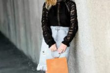 With black lace shirt, brown bag and black pumps