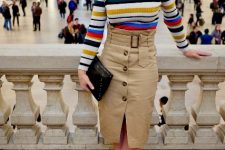 With colorful striped shirt, black clutch and white ankle boots