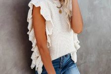With jeans and fringe embellished clutch