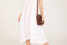 With straw hat, brown leather bag and brown leather flat sandals