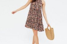 With straw tote bag and black flat sandals