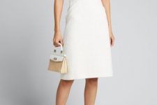 With white straw bag and white high heels