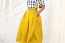 With yellow A-line midi skirt and sandals