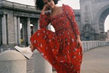 a beautiful red floral maxi dress with a square neckline and puff sleeves and white sneakers are a formula of a cool look
