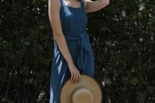 a blue linen maxi sundress on buttons, with thick straps, a square neckline, a sash and a straw hat for a vacation