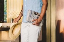 a blue linen shirt, white jeans, brown sandals and a bright neck tie plus a hat are cool for a hot day in summer
