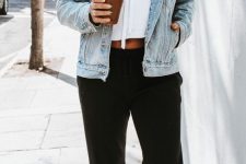 a casual look with a white cropped hoodie, black sweatpants, a blue denim jacket and white trainers