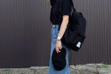 a comfy look with a black tee, a blue denim midi, black sneakers, a black baseball cap and a backpack for every day