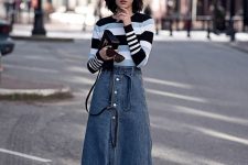 a contrasting striped jumper, a blue denim button up midi, black heels and a black bag for a chic look