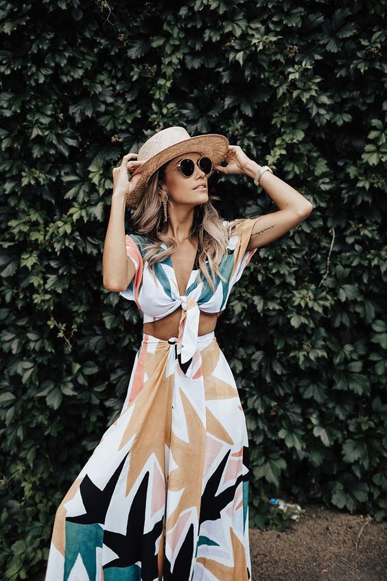 a dreamy vacation look with a printed botanical tied up crop top and a matching high waisted maxi skirt plus a straw hat