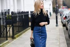 a flare blue denim midi skirt with buttons, a black turtleneck, black boots and a black bag for a French chic look