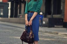 a green jumper, a blue denim button up midi, grey booties, a brown belt and a purple bag for a bold jewel-tone look