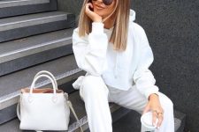 a perfect white outfit with a cropped hoodie, sweatpants, trainers and a bag is amazing