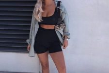 a sport outfit with a black crop top and biker shorts, a bleached chambray shirt, grey trainers and a small bag