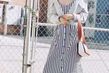 a striped navy and white linen midi sundress, brown mules, a distressed cropped denim jacket and a two tone bag