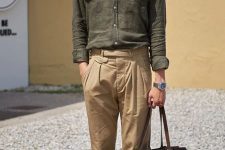 a stylish linen outfit with a green shirt, tan trousers, a brown bag and moccasins plus a neck tie