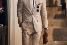 a total linen look with a white shirt and a tan pantsuit, brown shoes and elegant sunglasses for a cool office outfit