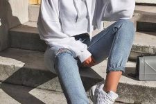a white cropped hoodie, blue high waisted jeans, white trainers for a veyr comfy and easy look
