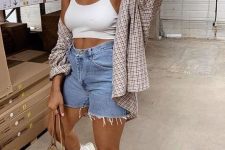 an everyday look with a white crop top, blue denim shorts, a plaid shirt, a headband, white socks and trainers plus a gold bag