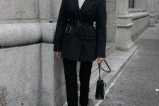 07 a dark fall look with a white turtleneck, black cropped jeans, a navy oversized blazer with a belt, a black bag and white heels