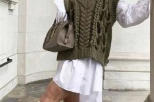 12 a white shirtdress, a green cable knit vest, creamy knee boots and a grey bag for a cold day