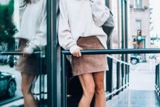 13 a blush suede mini skirt, an oversized turtleneck sweater, white booties for a simple and cool outfit