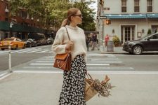 13 a fall outfit with a neutral sweater, a black printed midi skirt, rust suede booties and a rust-colored bag