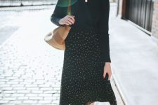 14 a black jumper, a coin necklace, a black polka dot midi skirt, black sneakers and a straw bag for a Parisian look