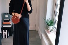18 a refined outfit with a black turtleneck, a navy slip midi skirt, black boots and a round red bag is cool