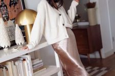 22 a blush slip midi skirt, an oversized white cardigan, black flat mules for a cute girlish look