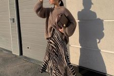 22 a taupe chunky sweater, a zebra print midi slip skirt, black heels and a taupe bag for a refined look