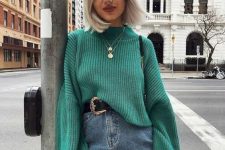 24 a lovely and girlish outfit with a green chunky sweater, a blue denim mini, a black belt and layered necklaces