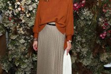 25 a rust-colored oversized turtleneck, a neutral plaid midi skirt, black boots and a black belt for the fall
