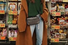 27 a lovely fall outfit with a green turtleneck sweater, blue jeans, green sneakers, a brown coat and a black printed bag